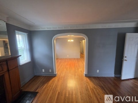 A room with wooden floors and a white door.