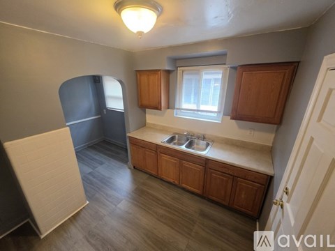 A kitchen with a sink and a window.