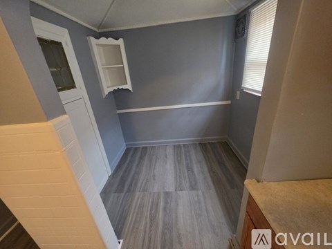 A room with grey walls and wooden flooring.
