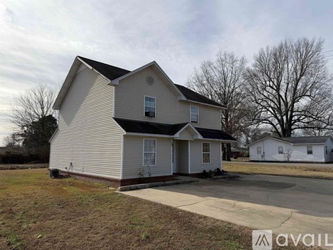 A two-story house with a garage is available for sale.