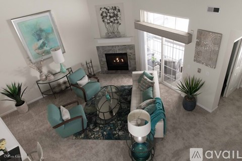 A living room with a fireplace and a painting on the wall.