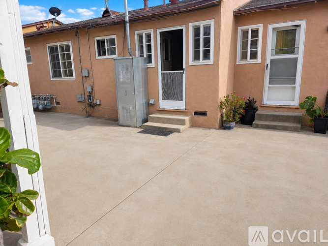 A house with a brown exterior and a grey metal gate.