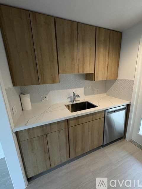 A kitchen with wooden cabinets and a white countertop.