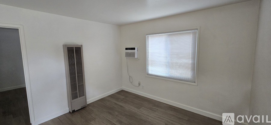A room with a window and a door.