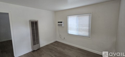 A room with a window and a door.