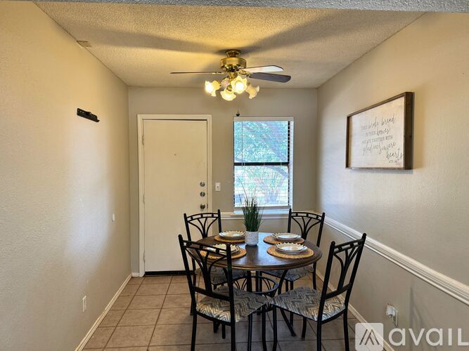 A dining room with a table set for four.