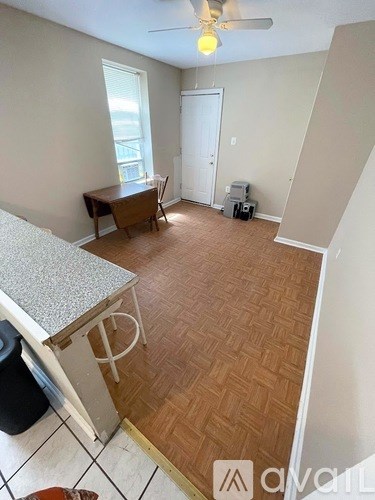 A kitchen with a counter and a fan.