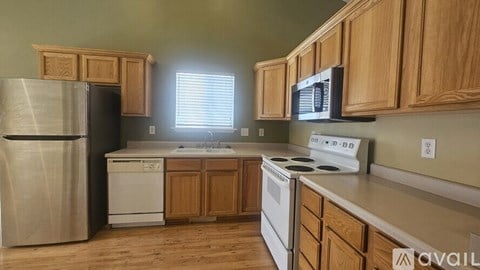 A kitchen with wooden cabinets and stainless steel appliances.
