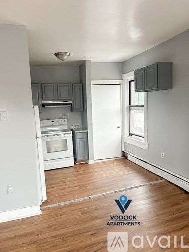 A kitchen with a white oven and a white fridge.