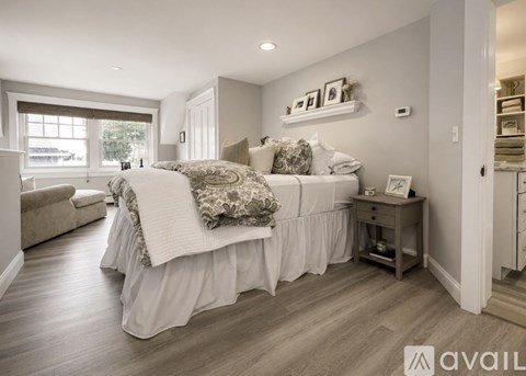 A bedroom with a large bed and a desk.