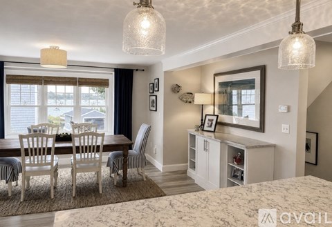 A well-lit dining area with a table set for four.