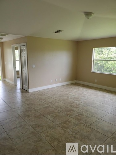 A room with tile flooring and a window.