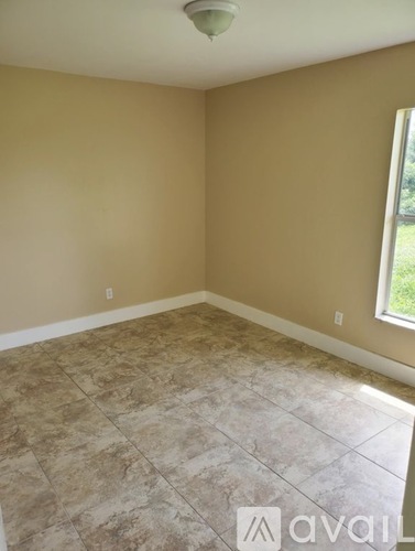 A room with beige walls and a tiled floor.