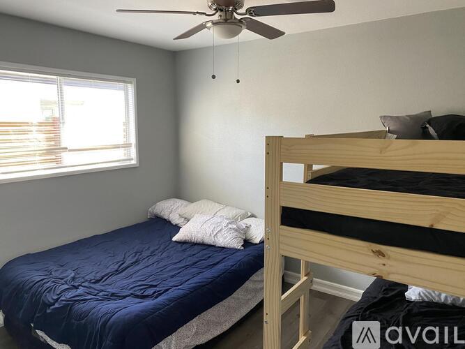 A bedroom with a bed and a bunk bed.