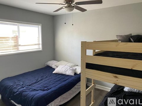 A bedroom with a bed and a bunk bed.