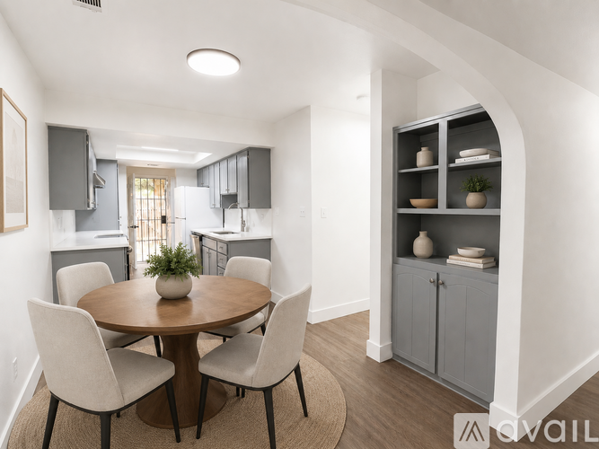 A modern dining room with a round table and chairs.