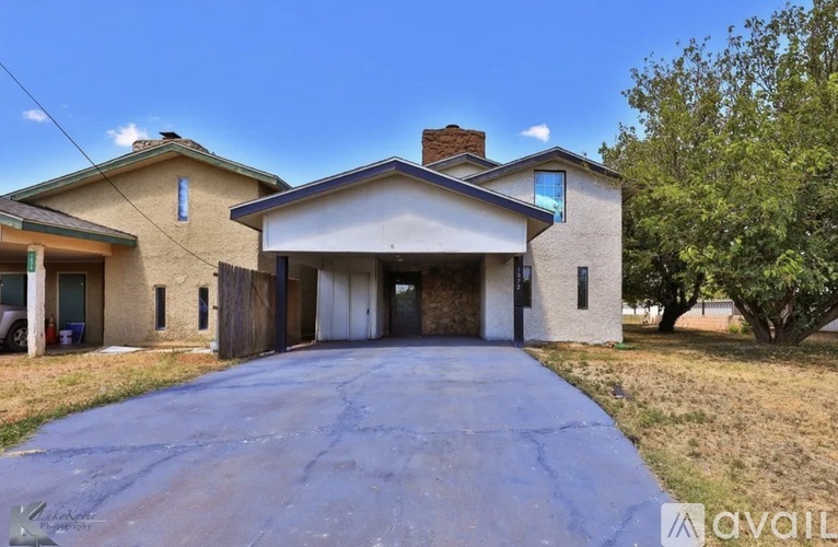 A house with a driveway in front of it is for sale.