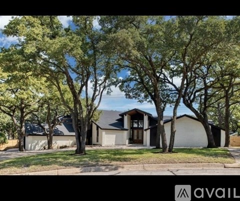 A house with a tree in front of it.