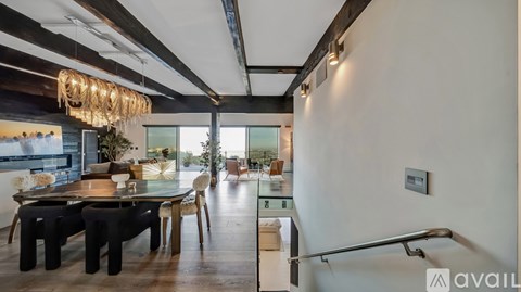 A modern dining area with a glass table and chairs.