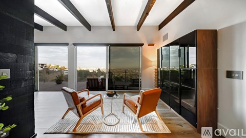 A modern living room with a glass table and chairs.
