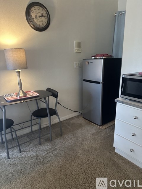 A small kitchen with a table and chairs.