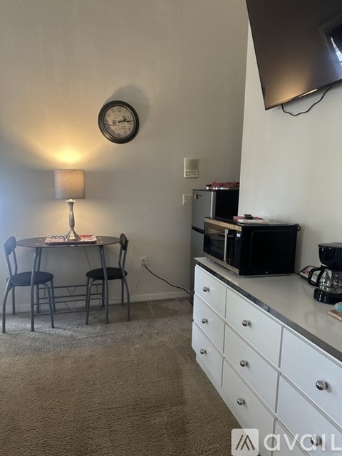 A small dining room with a table and two chairs.