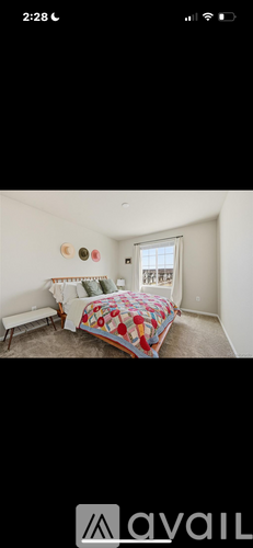 A bedroom with a bed and a window.