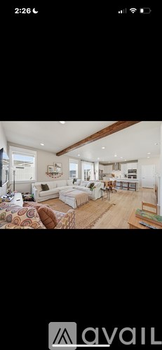 A well-lit, spacious living room with a couch and a coffee table.