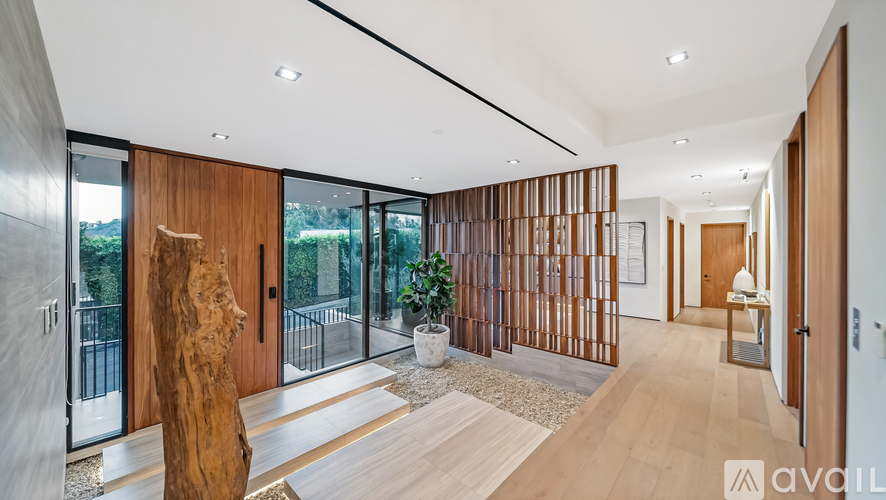A modern interior space with wooden floors and a large window.