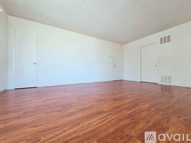 A room with wooden floors and white walls.