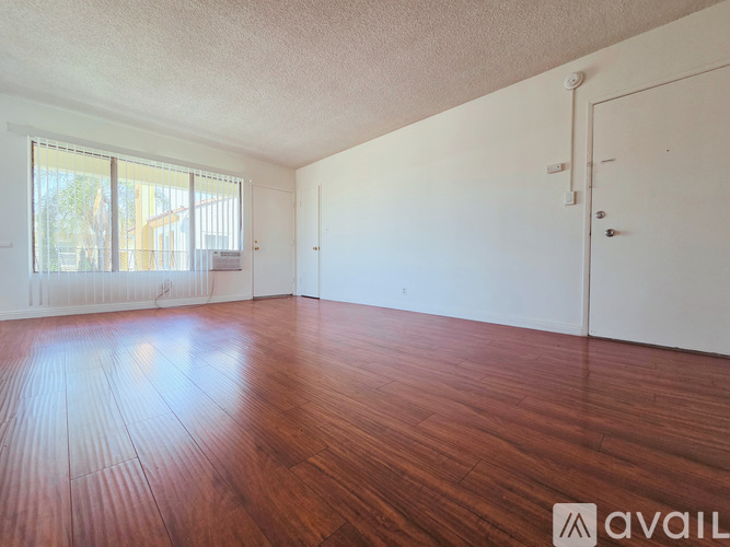 A room with wooden floors and white walls.
