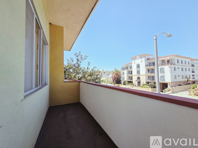 A balcony with a view of a street and buildings.