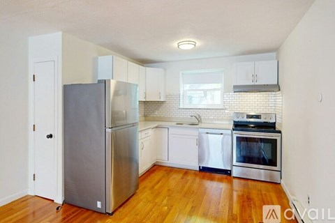 A kitchen with a stainless steel refrigerator and oven.