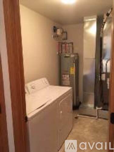 A small laundry room with a washer and dryer.