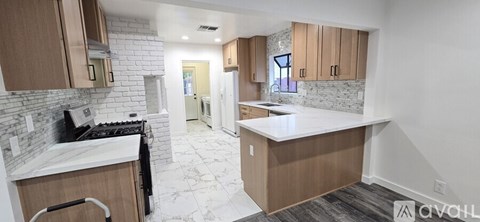 A kitchen with wooden cabinets and a white countertop.