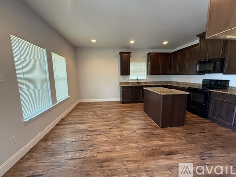 A kitchen with wooden floors and a countertop.