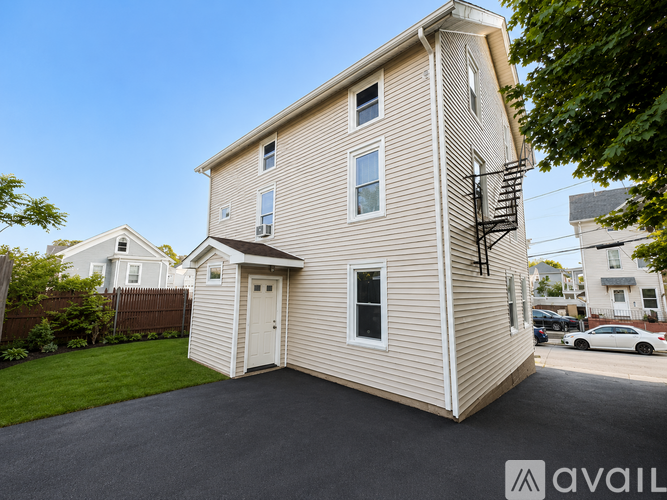 A two-story house with a garage and a balcony on the second floor.
