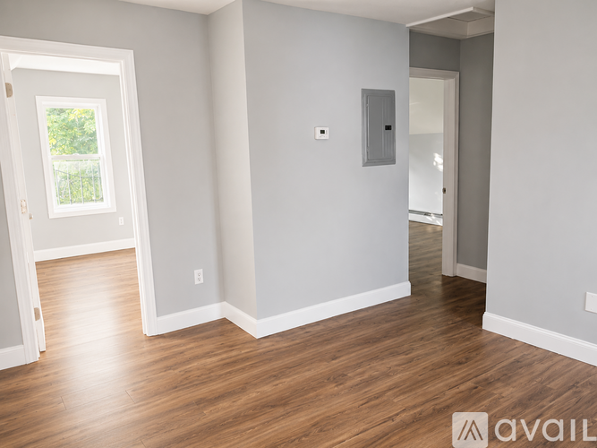 A room with wooden floors and white walls.