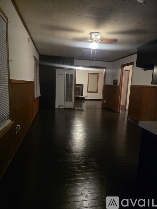 A long hallway with a light on the ceiling.