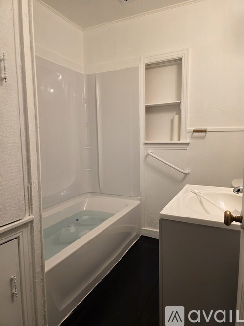 A bathroom with a glass shower door and a white sink.