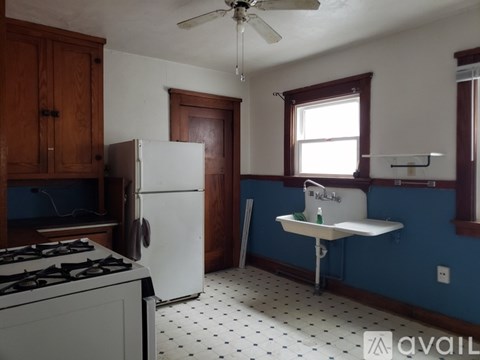 A kitchen with a white fridge and a white stove.