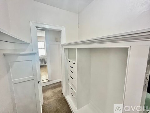 A white room with a door and a window.