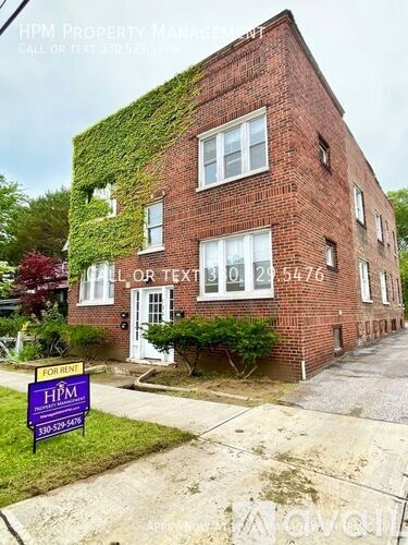 A red brick building with a sign in front that says HPM Property Management.