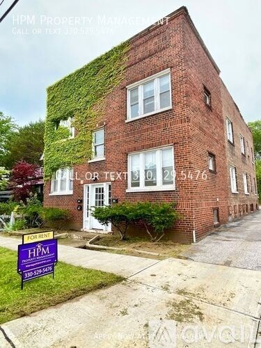A red brick building with a sign in front that says HPM Property Management.