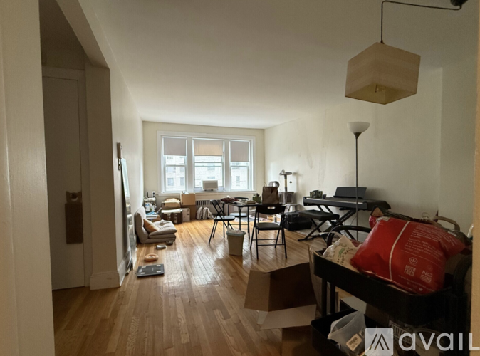 A living room with a couch, chairs, and a table.
