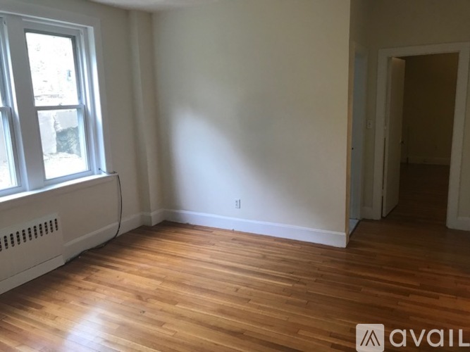 A room with wooden floors and a window.