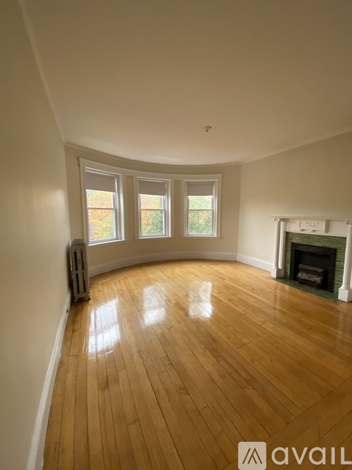 A room with wooden floors and a fireplace.