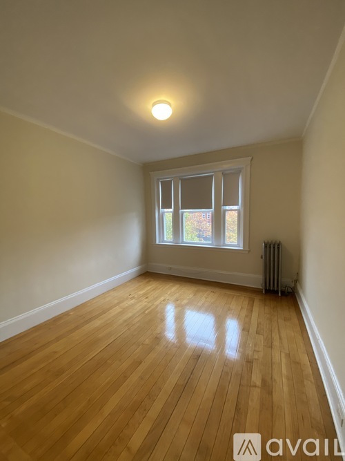 A room with wooden floors and a window.