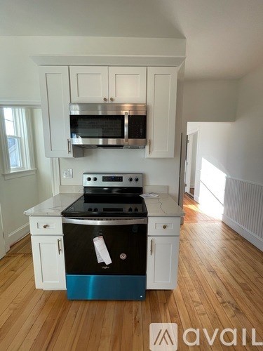 A kitchen with a stove top oven and microwave above it.