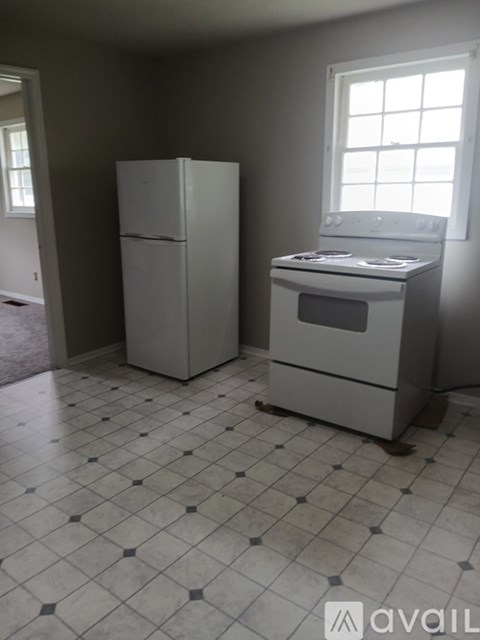 A kitchen with a white fridge and a white oven.